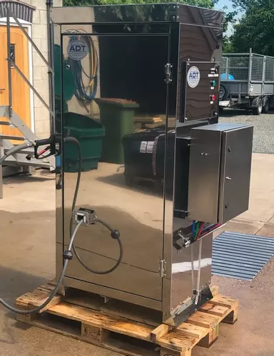 Completed stainless steel wheel wash system built into a DTE cabinet, designed for outdoor installation at a hatchery. This bespoke unit houses a CAT pump, multi-stage detergent system, internal hose reel, and water inlet tank to provide a controlled and 
